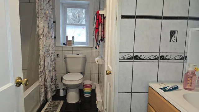 a bathroom with a toilet and a shower