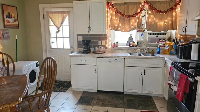a kitchen with a sink cabinets and appliances