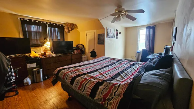 a bedroom with bed and a chandelier