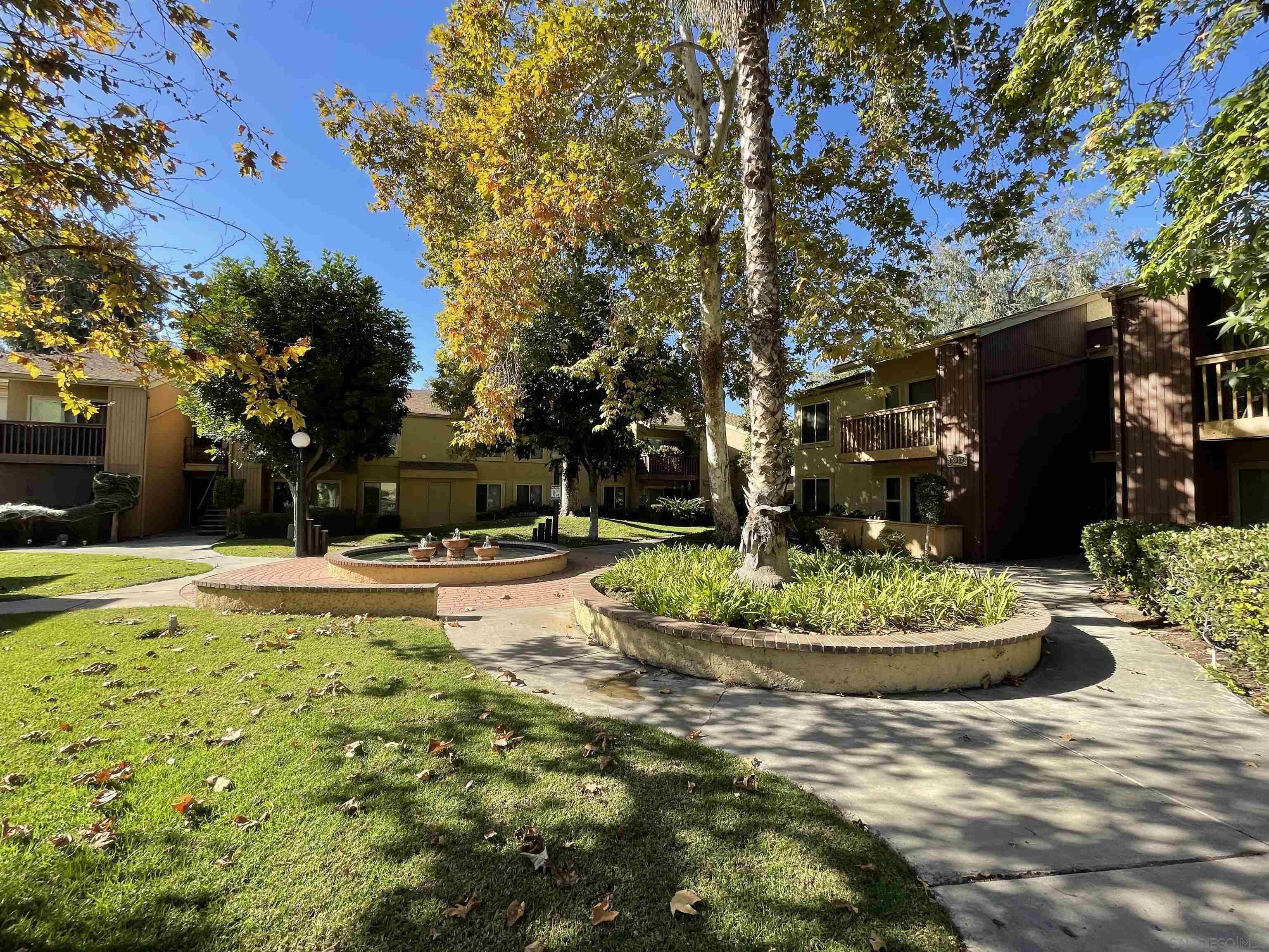 5938 Rancho Mission Road, Unit 129 San Diego, CA 92108 - Photo 13 of 29 a view of a swimming pool with a garden