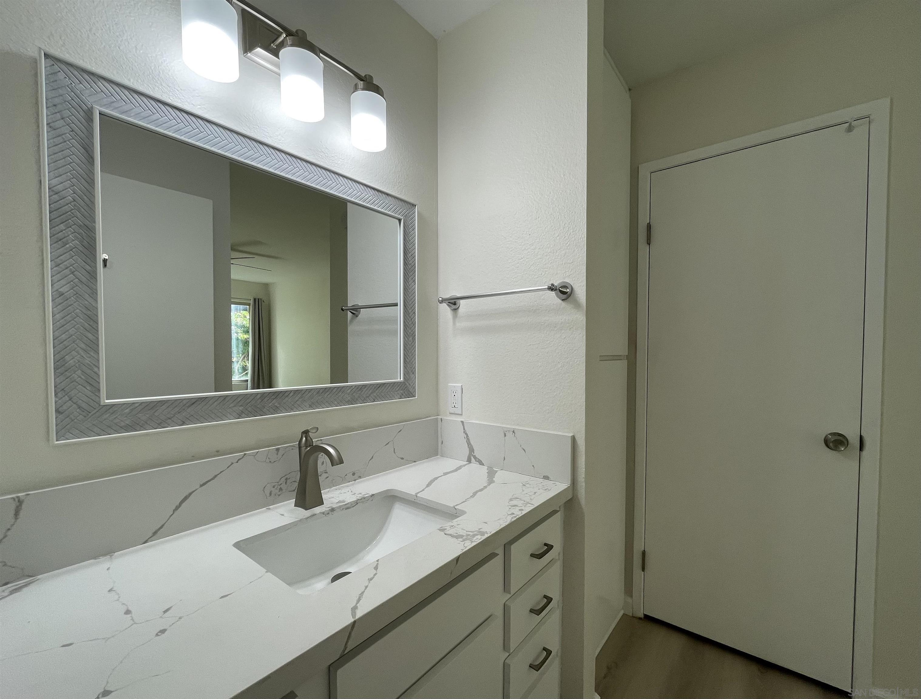 5938 Rancho Mission Road, Unit 129 San Diego, CA 92108 - Photo 16 of 29 a bathroom with a sink and a mirror