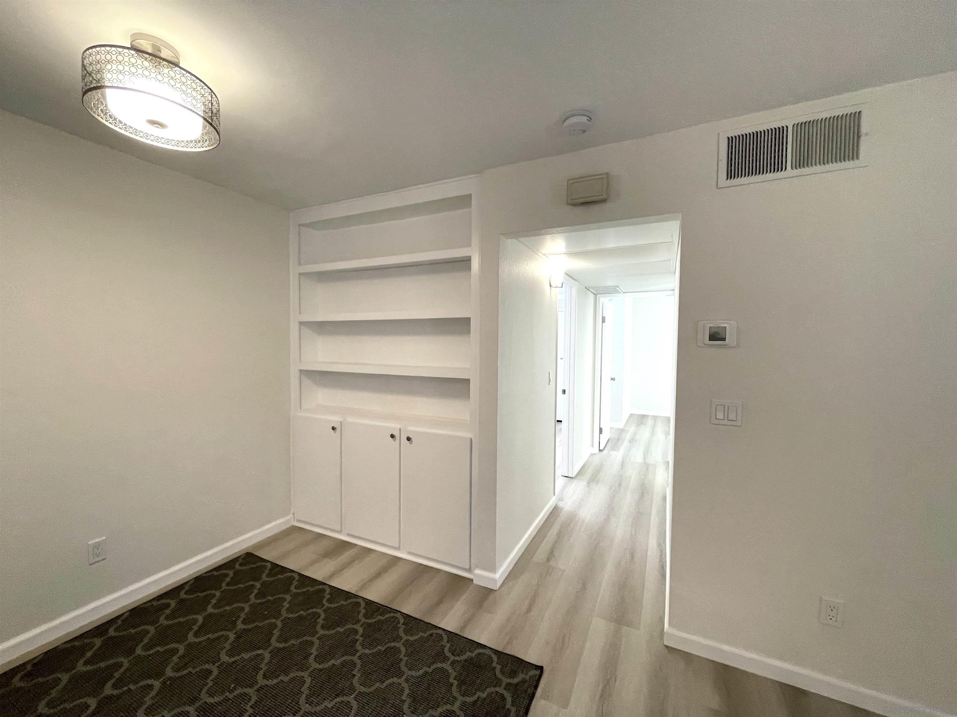 5938 Rancho Mission Road, Unit 129 San Diego, CA 92108 - Photo 19 of 29 a view of a room with wooden floor