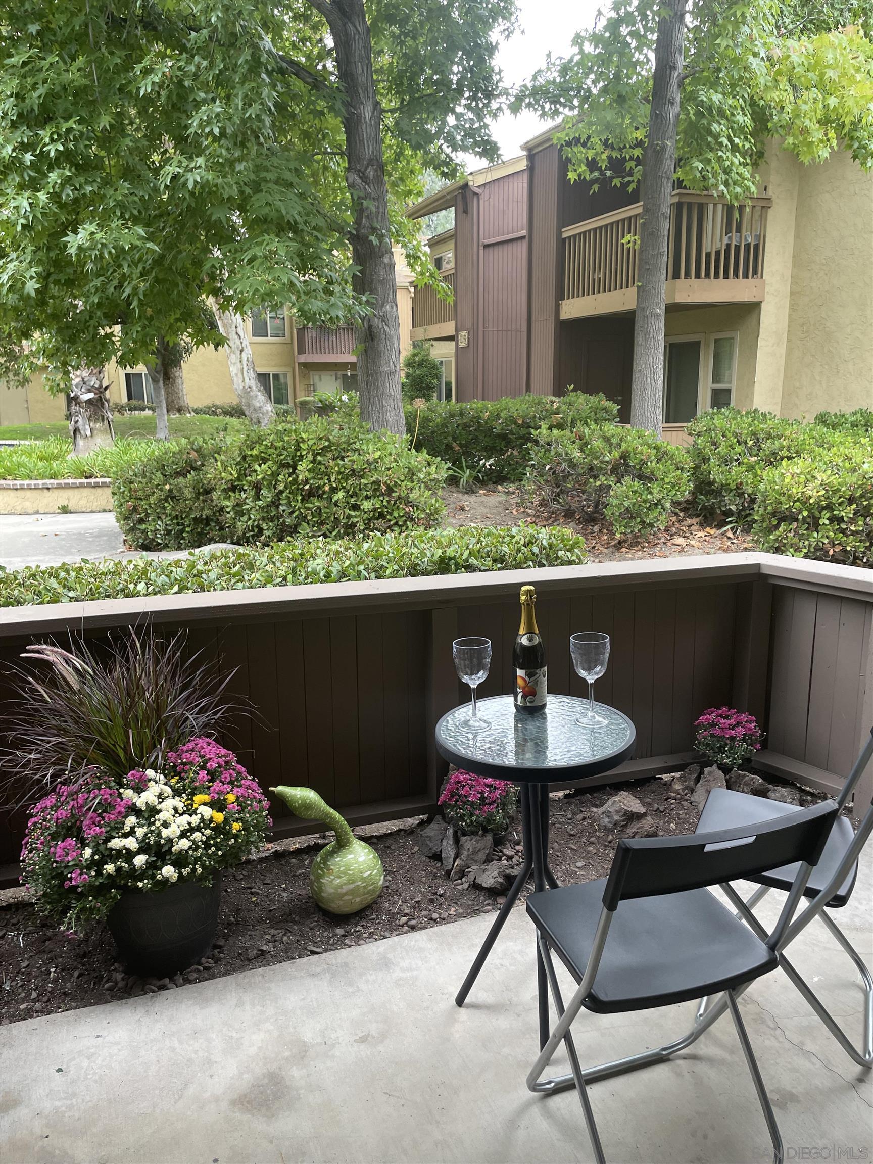 5938 Rancho Mission Road, Unit 129 San Diego, CA 92108 - Photo 24 of 29 a view of a chairs and table in a backyard