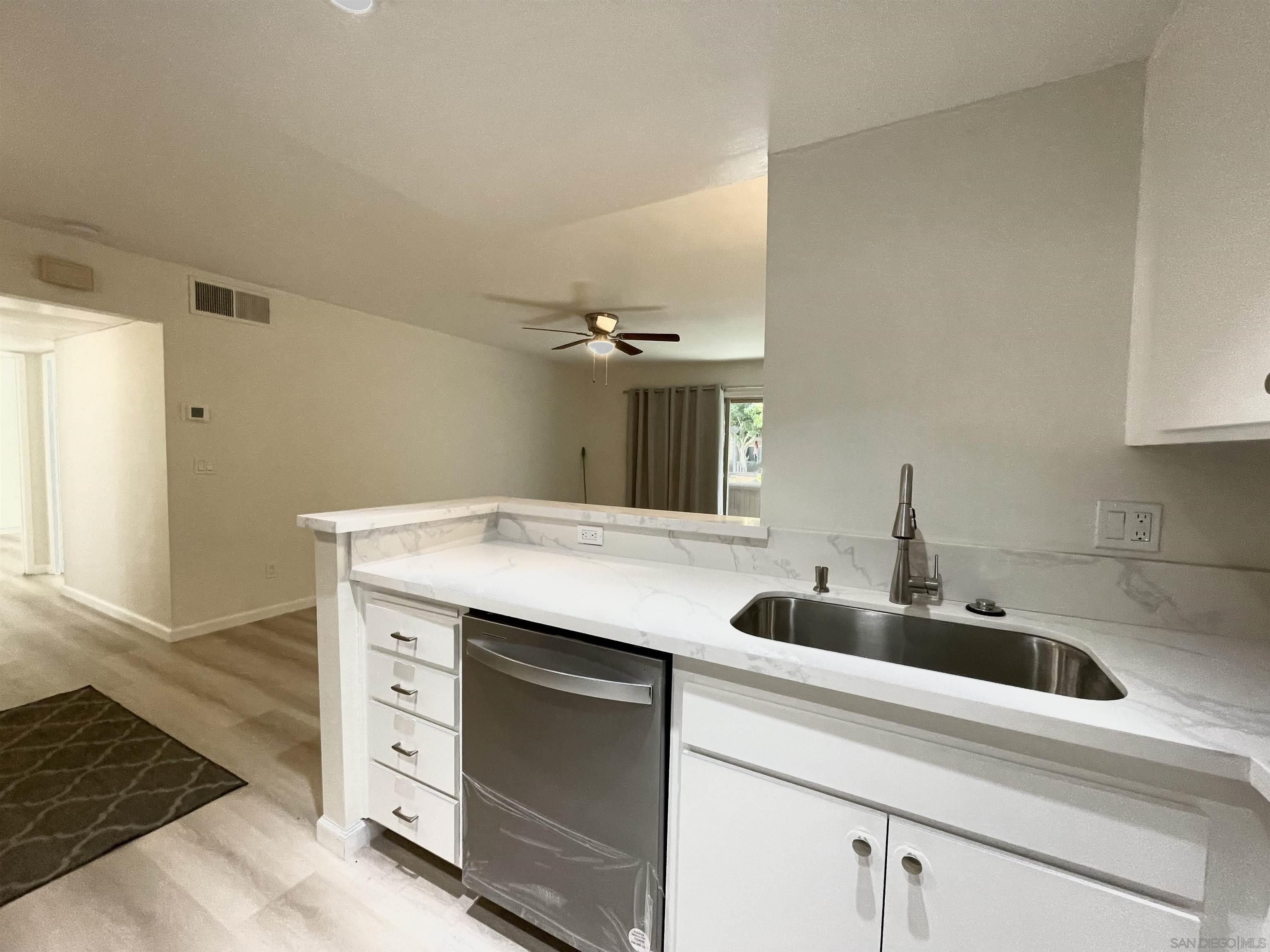 5938 Rancho Mission Road, Unit 129 San Diego, CA 92108 - Photo 25 of 29 a kitchen with a sink and cabinets