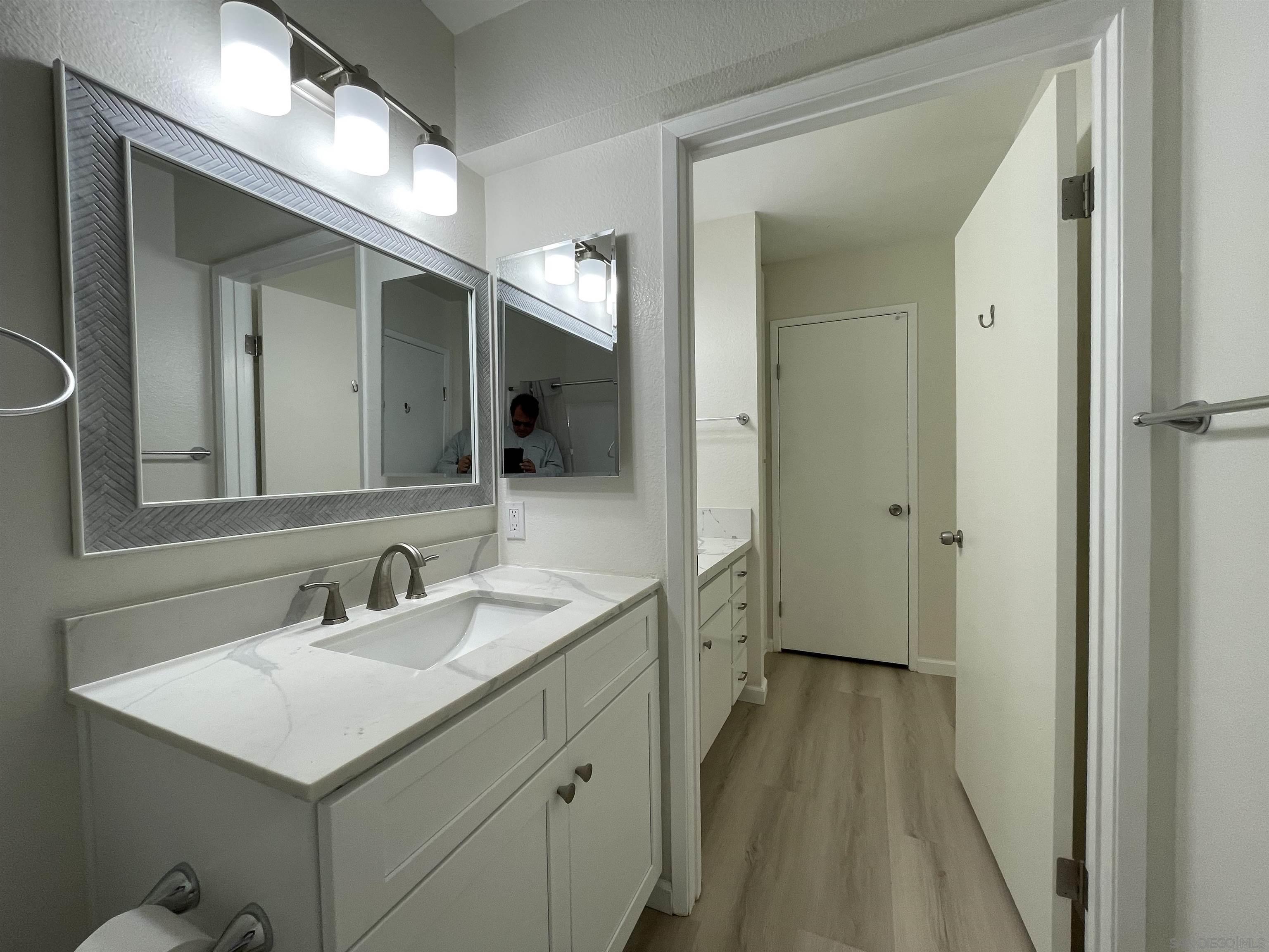5938 Rancho Mission Road, Unit 129 San Diego, CA 92108 - Photo 3 of 29 a bathroom with a sink and a mirror