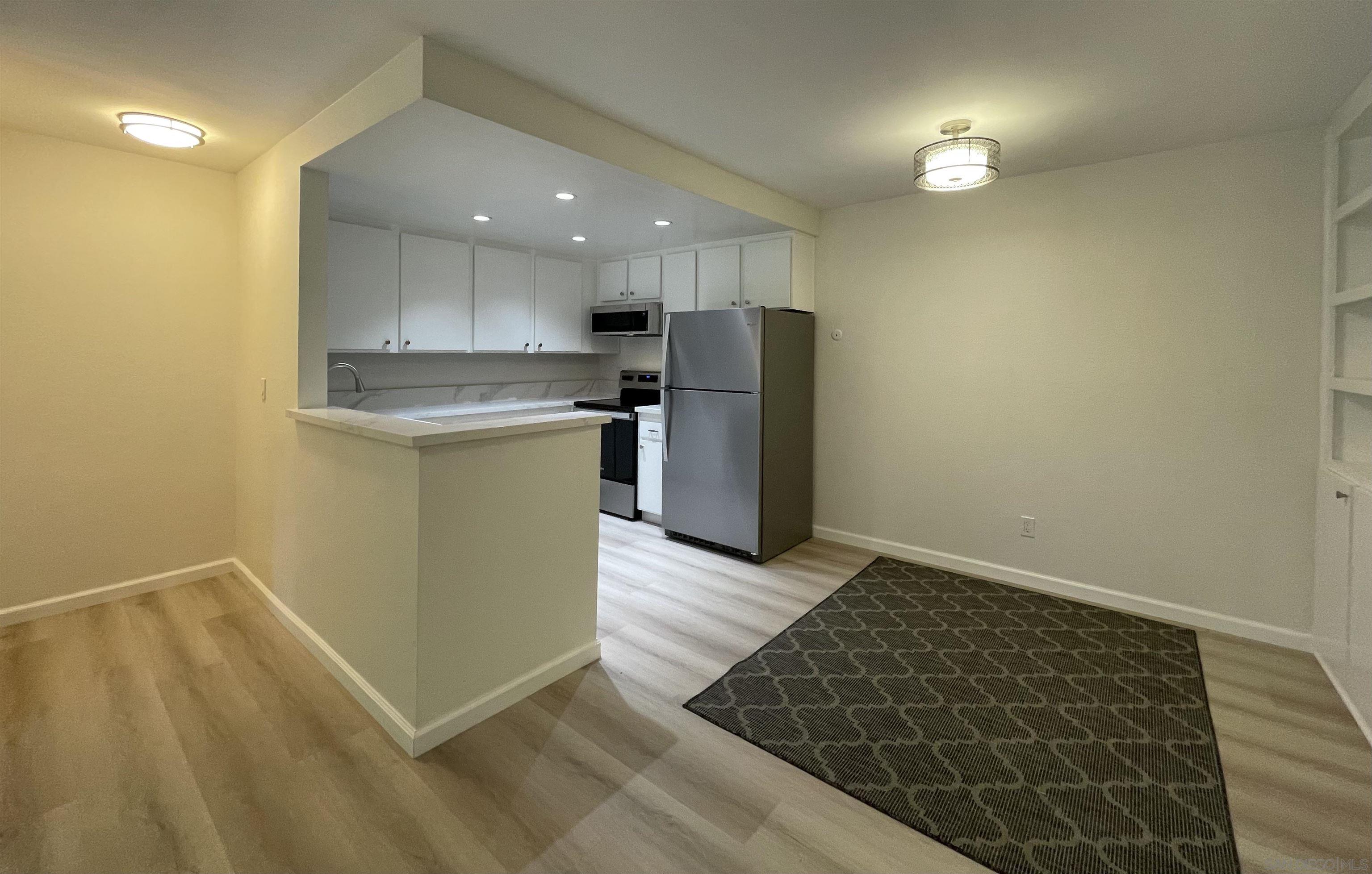 5938 Rancho Mission Road, Unit 129 San Diego, CA 92108 - Photo 5 of 29 a kitchen with a sink and a refrigerator