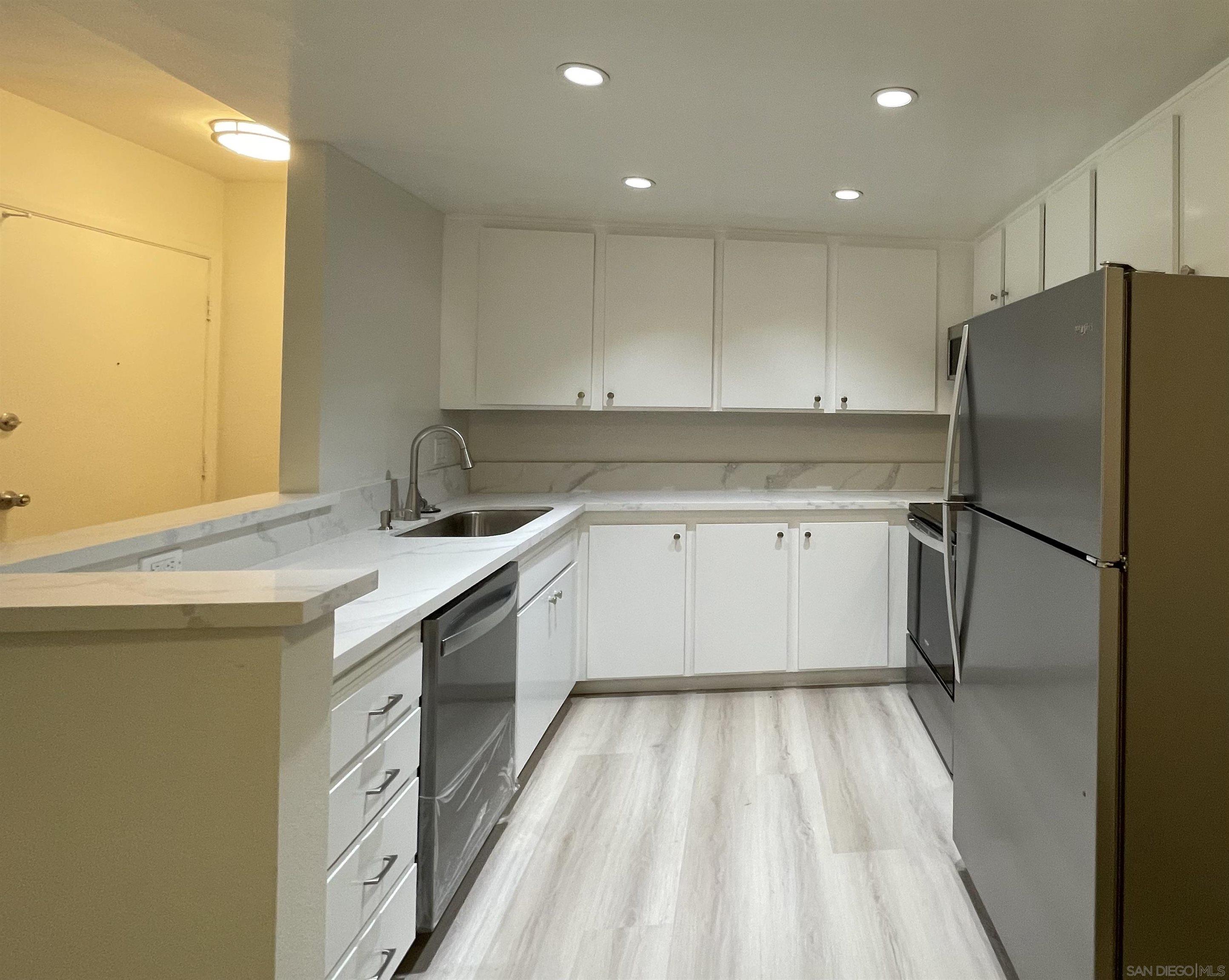 5938 Rancho Mission Road, Unit 129 San Diego, CA 92108 - Photo 6 of 29 a kitchen with a sink a refrigerator and window