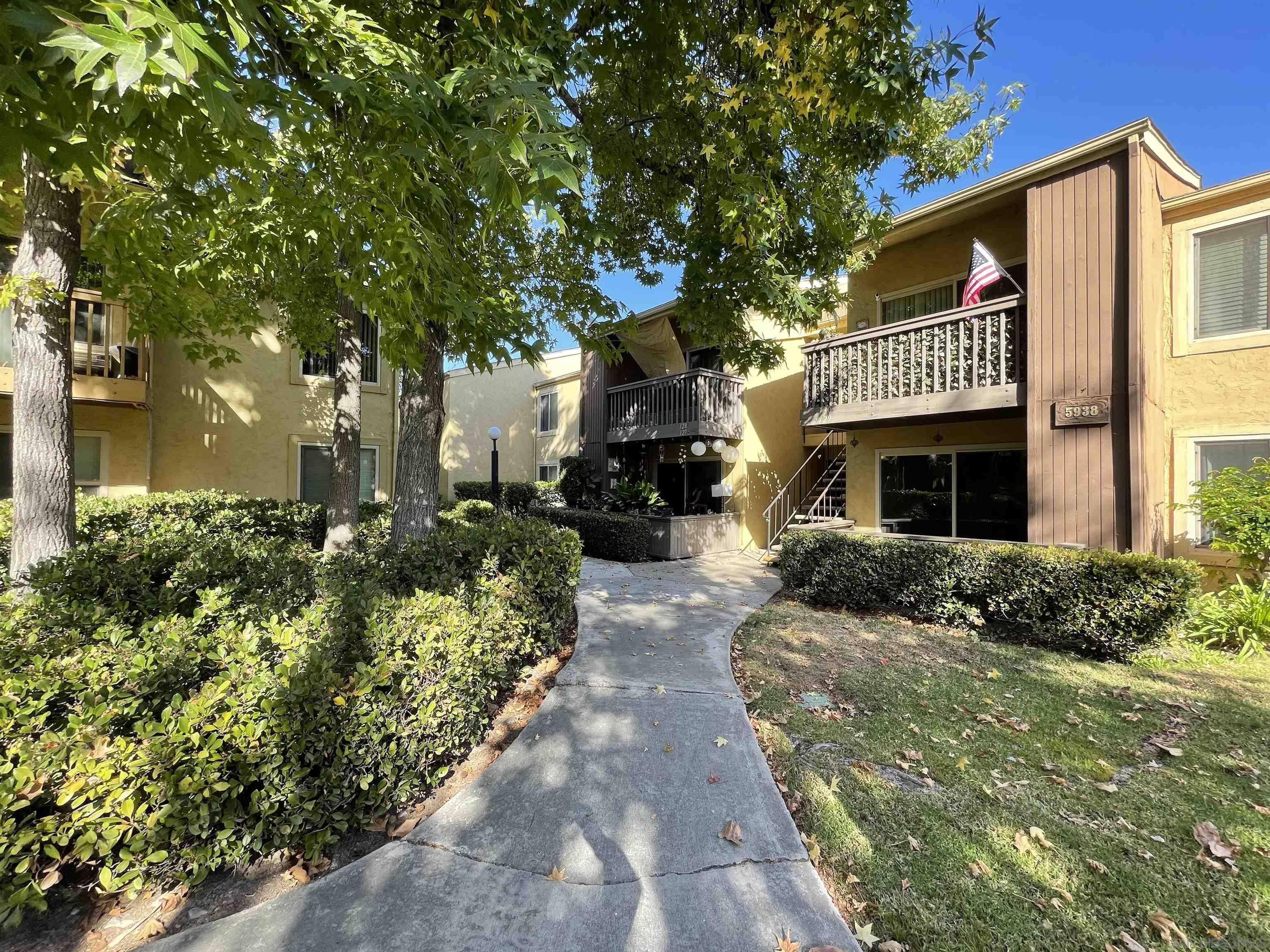 5938 Rancho Mission Road, Unit 129 San Diego, CA 92108 - Photo 8 of 29 a front view of a house with a garden
