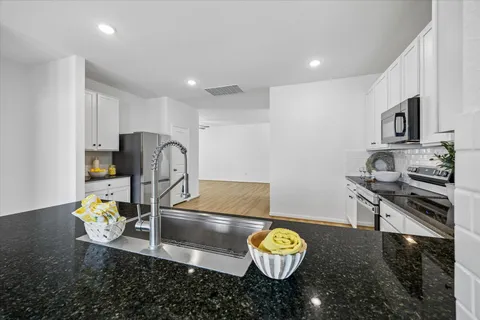 a kitchen with a stove and a refrigerator