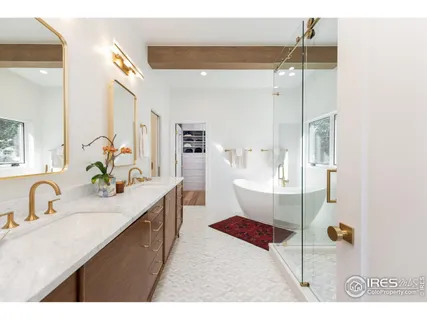 a large bathroom with a double vanity sink a mirror and a shower