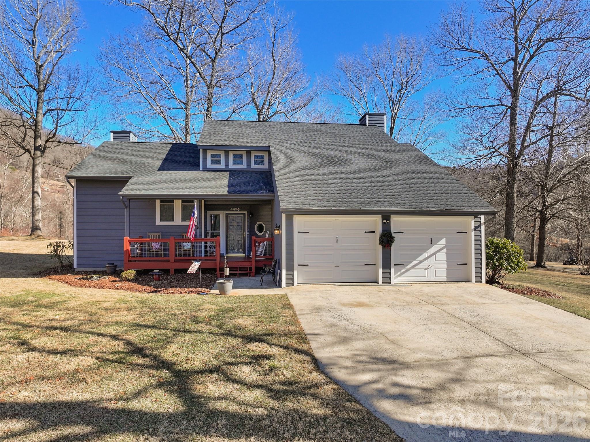 a view of a house with a patio and a yard