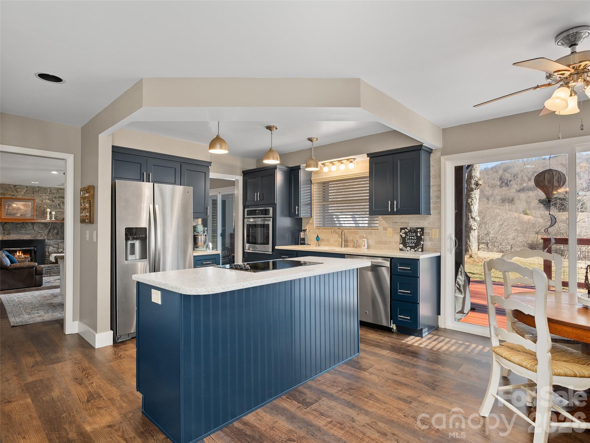 1672 Worley Cove Road Canton, NC 28716 - Photo 17 of 39 a large kitchen with stainless steel appliances kitchen island granite countertop a refrigerator and a sink