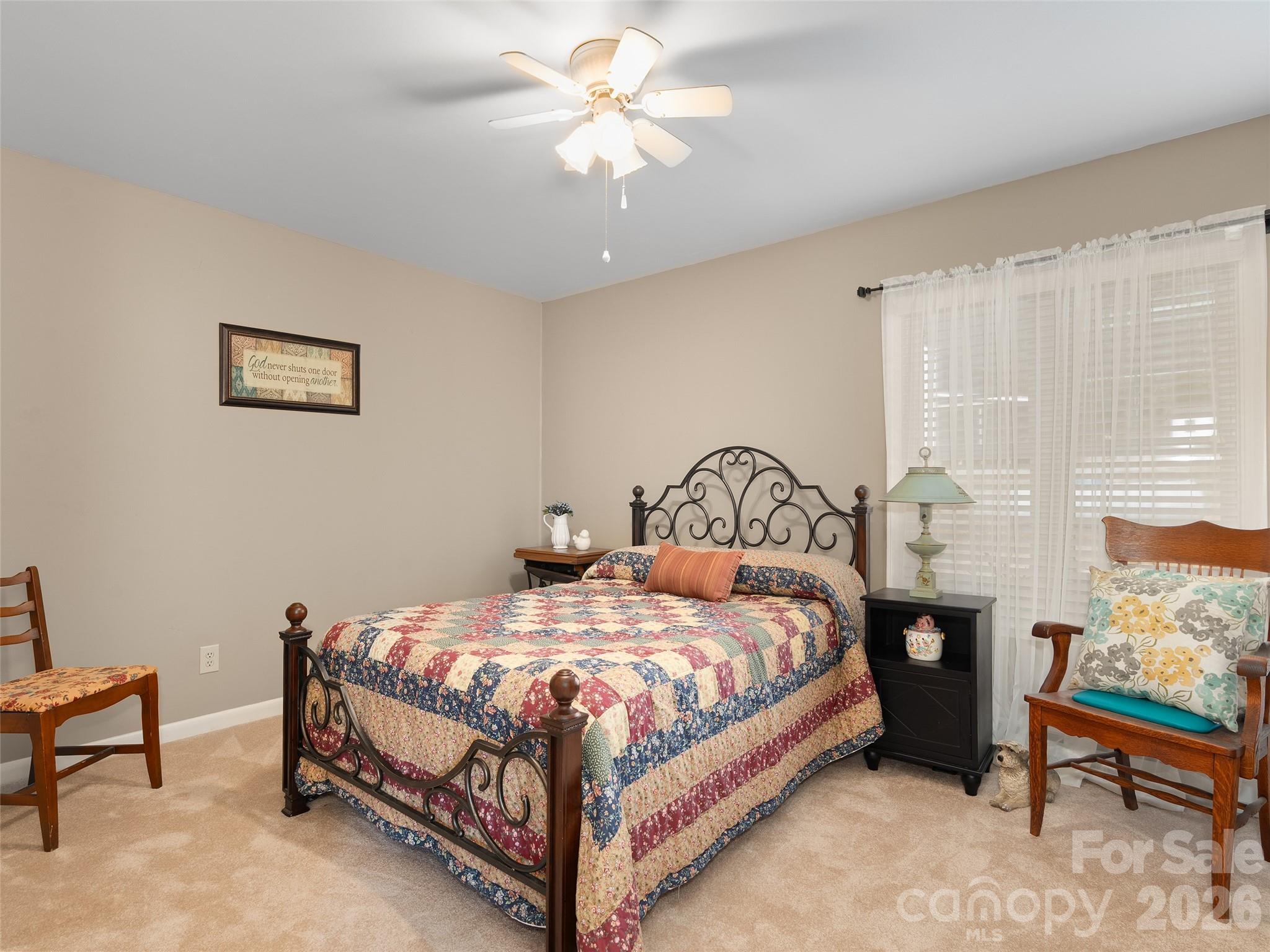1672 Worley Cove Road Canton, NC 28716 - Photo 23 of 39 a bedroom with a bed and a chandelier