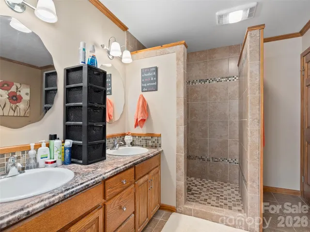 a bathroom with a sink vanity granite and shower