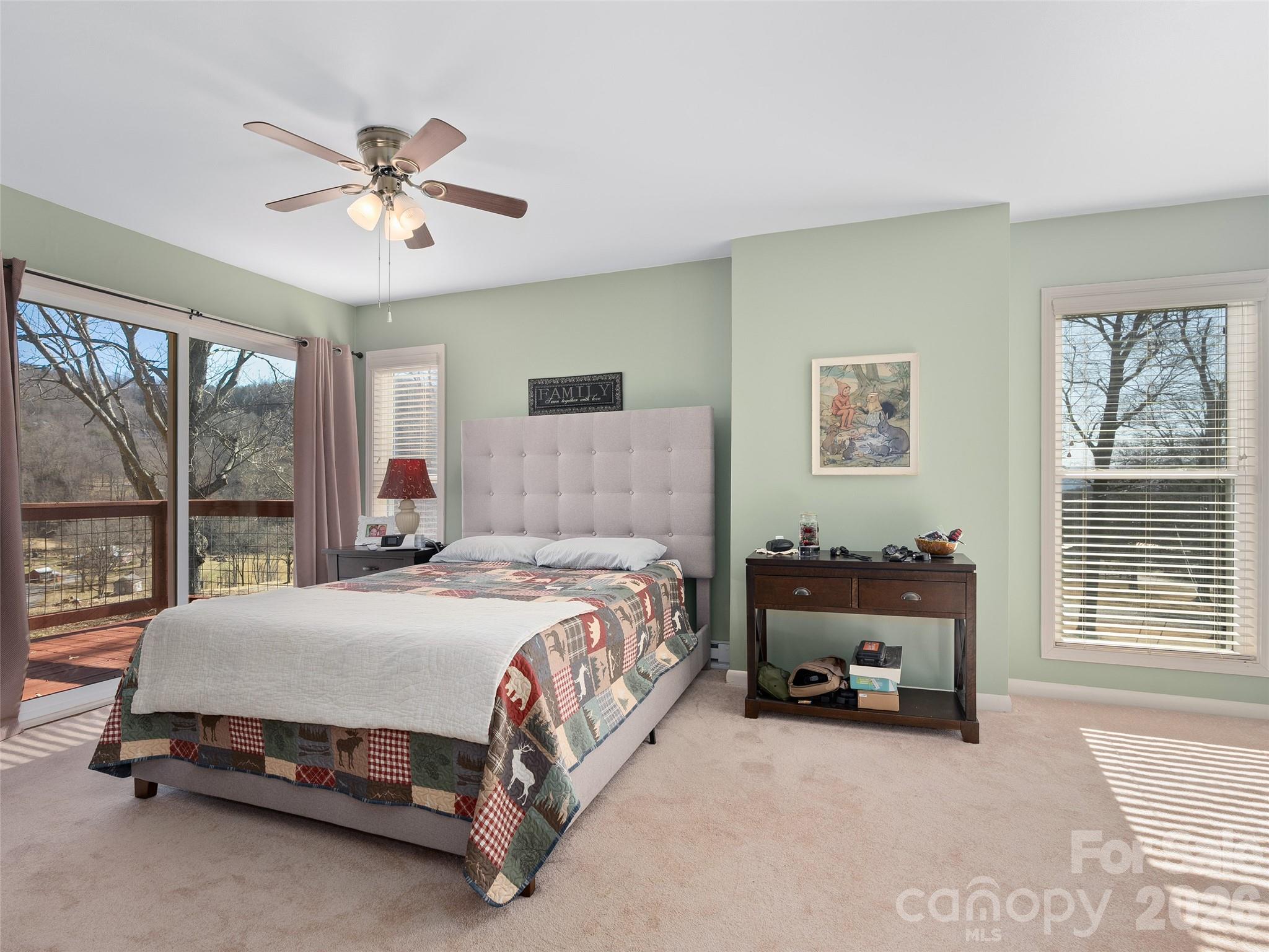 1672 Worley Cove Road Canton, NC 28716 - Photo 34 of 39 a bedroom with a bed and a chandelier
