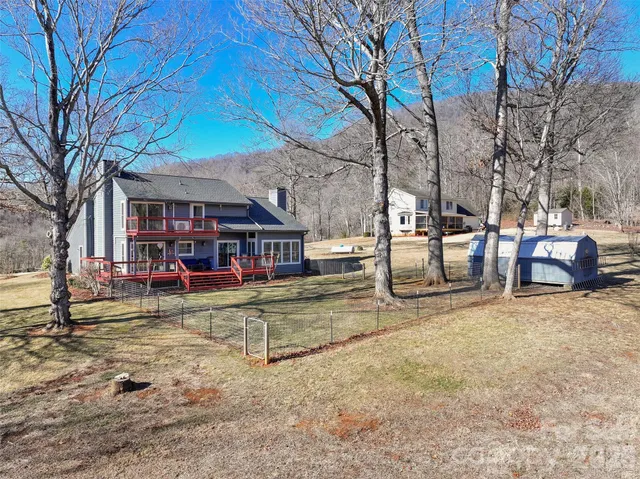 a view of a house with a yard covered in snow