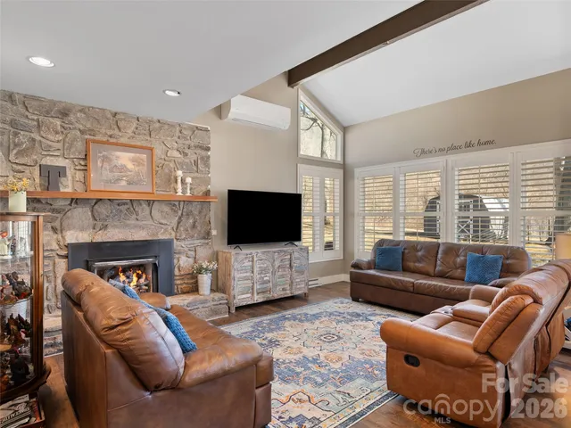 a living room with fireplace furniture and a flat screen tv