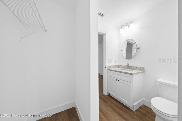 9002 Nakoma Way Weeki Wachee, FL 34613 - Photo 13 of 15 a bathroom with a sink toilet vanity and mirror