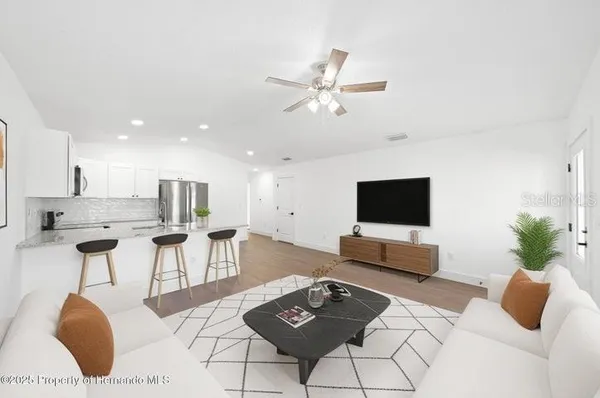 a living room with furniture and a flat screen tv