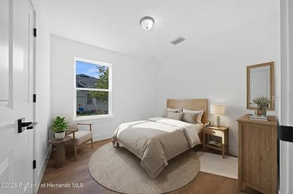 a bedroom with a bed and a window