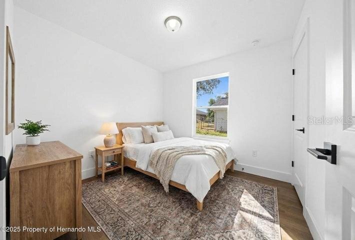 9002 Nakoma Way Weeki Wachee, FL 34613 - Photo 9 of 15 a bedroom with a bed and a window