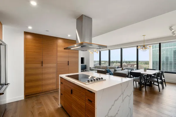 a large kitchen with a table and chairs