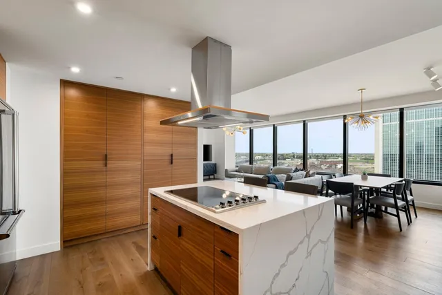 a large kitchen with a table and chairs