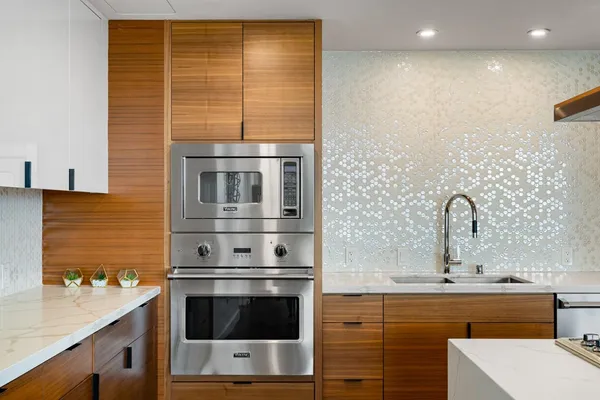 a kitchen with stainless steel appliances a sink stove and refrigerator
