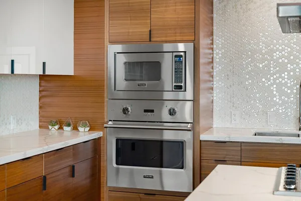 a kitchen with stainless steel appliances granite countertop a sink stove and cabinets
