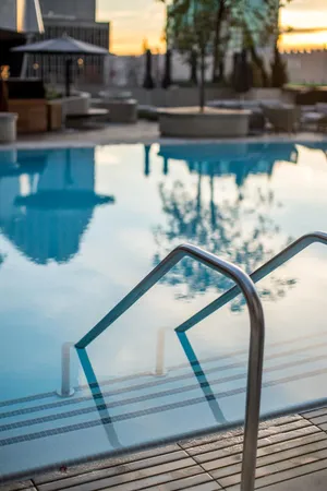 a view of a swimming pool with outdoor seating and city view