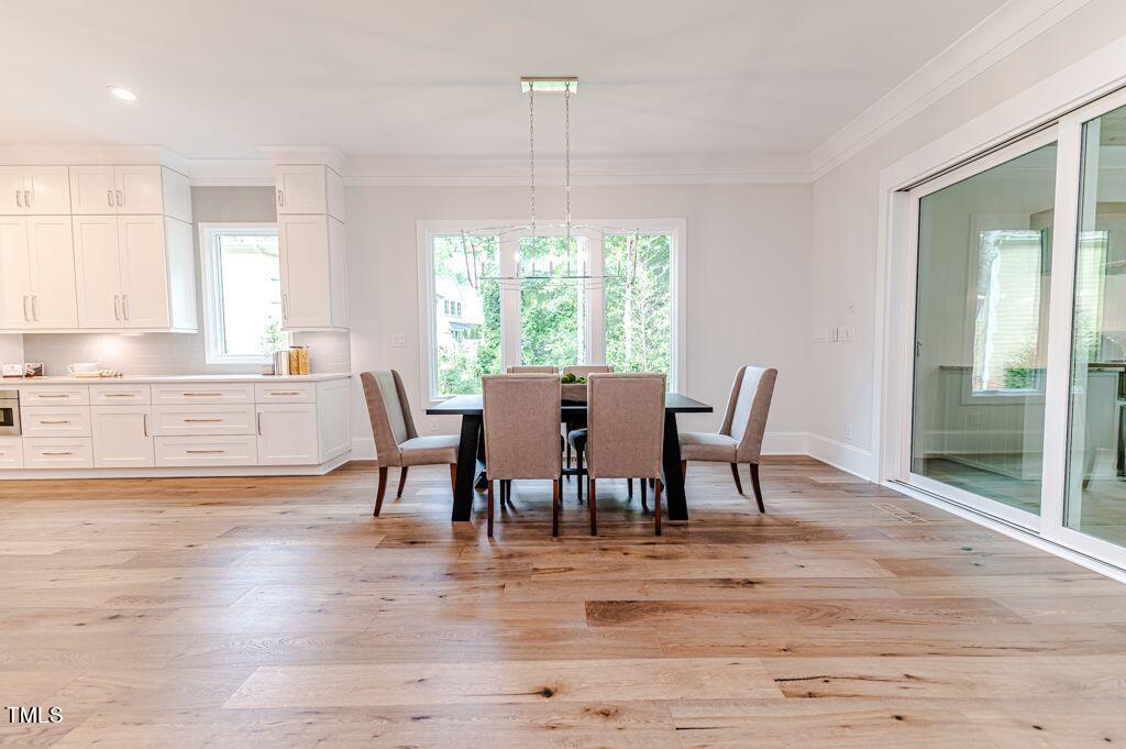 2101 Gresham Lake Road Raleigh, NC 27615 - Photo 11 of 48 a view of a dining room with furniture window and wooden floor