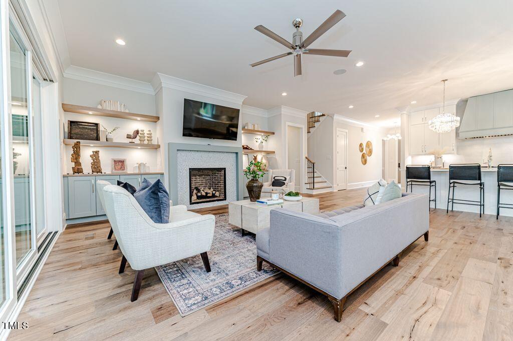 2101 Gresham Lake Road Raleigh, NC 27615 - Photo 12 of 48 a living room with furniture a fireplace and a flat screen tv
