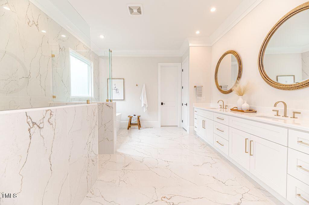 2101 Gresham Lake Road Raleigh, NC 27615 - Photo 16 of 48 a spacious bathroom with a double vanity sink and a mirror