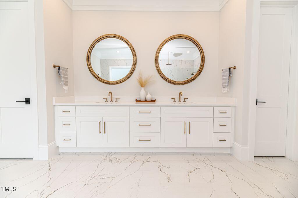 2101 Gresham Lake Road Raleigh, NC 27615 - Photo 17 of 48 a bathroom with a double vanity sink and a mirror