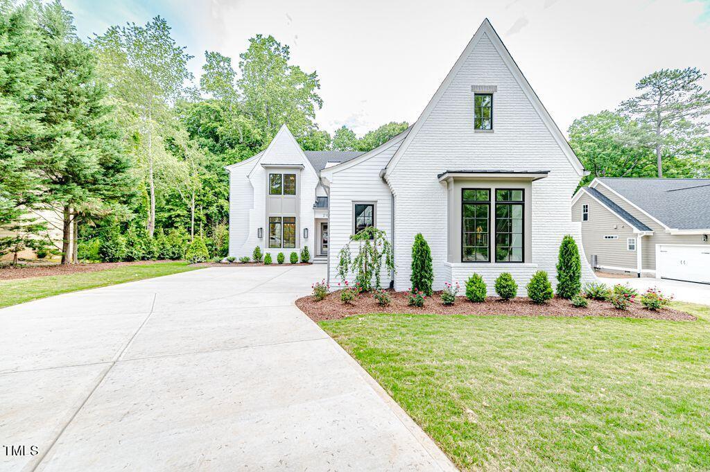 2101 Gresham Lake Road Raleigh, NC 27615 - Photo 2 of 48 a front view of a house with a yard and potted plants