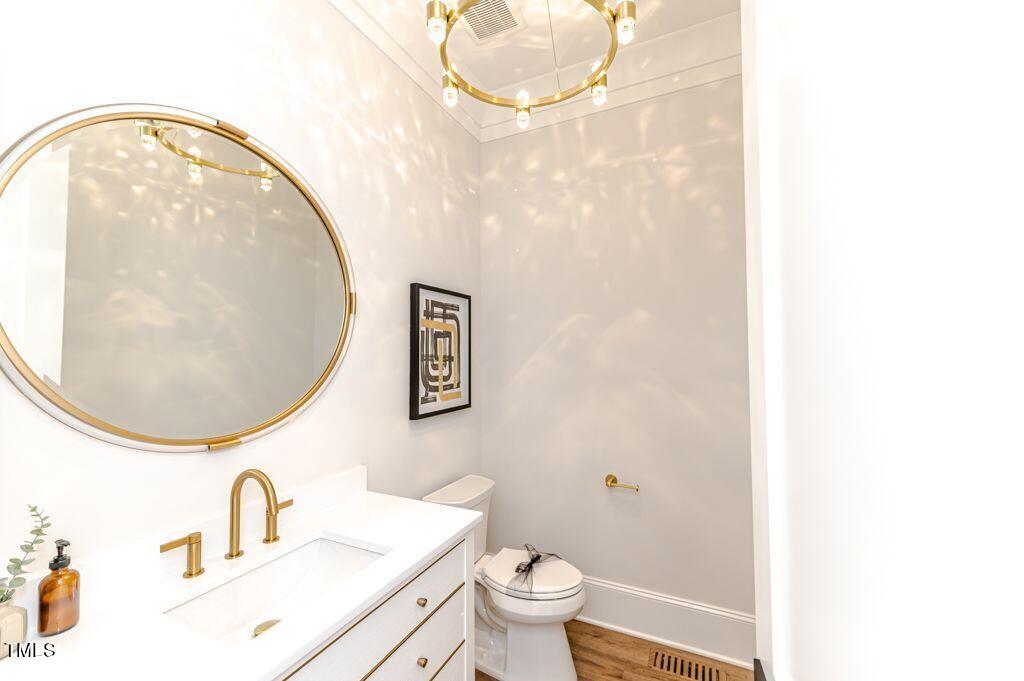 2101 Gresham Lake Road Raleigh, NC 27615 - Photo 23 of 48 a bathroom with a sink a mirror and a toilet