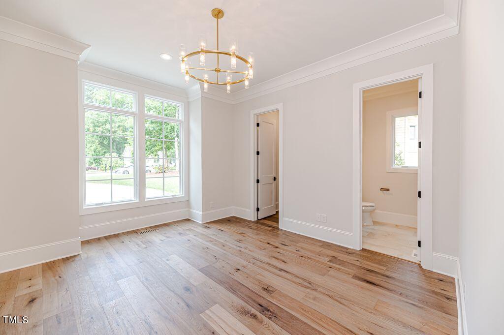 2101 Gresham Lake Road Raleigh, NC 27615 - Photo 25 of 48 a view of an empty room with wooden floor and a window