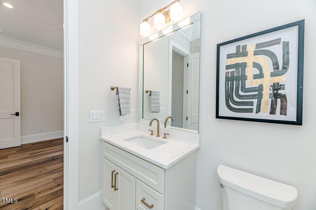 2101 Gresham Lake Road Raleigh, NC 27615 - Photo 26 of 48 a bathroom with a toilet a sink and mirror