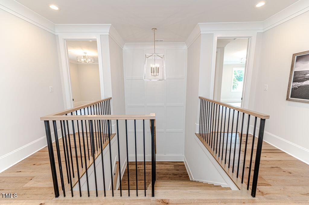 2101 Gresham Lake Road Raleigh, NC 27615 - Photo 29 of 48 a view of a hallway with wooden floor and windows