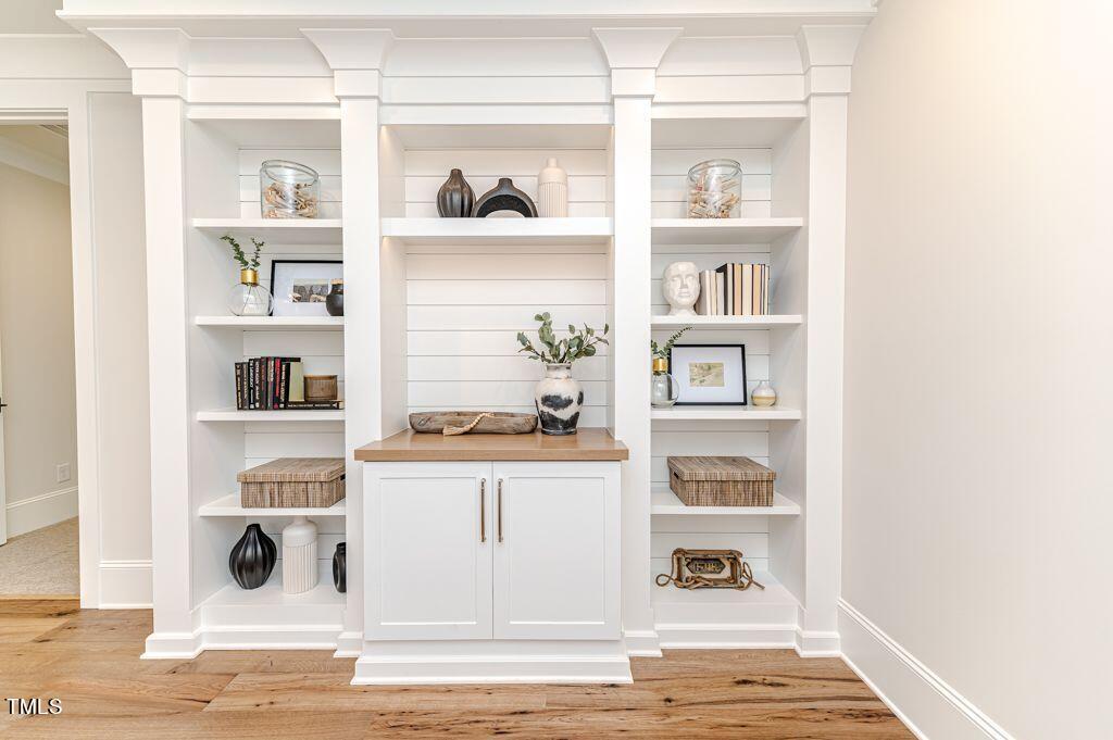 2101 Gresham Lake Road Raleigh, NC 27615 - Photo 30 of 48 a shelf with books and knick knacks on it