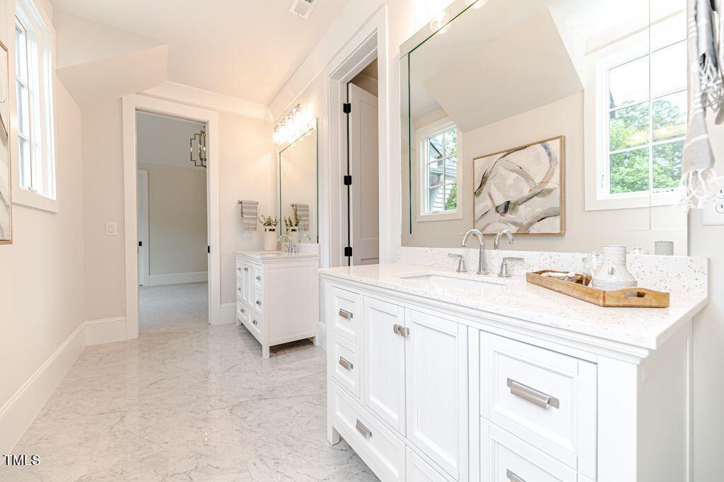 2101 Gresham Lake Road Raleigh, NC 27615 - Photo 38 of 48 a bathroom with a sink vanity granite tub shower and a mirror