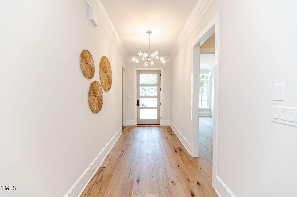2101 Gresham Lake Road Raleigh, NC 27615 - Photo 4 of 48 a view of a hallway with wooden floor