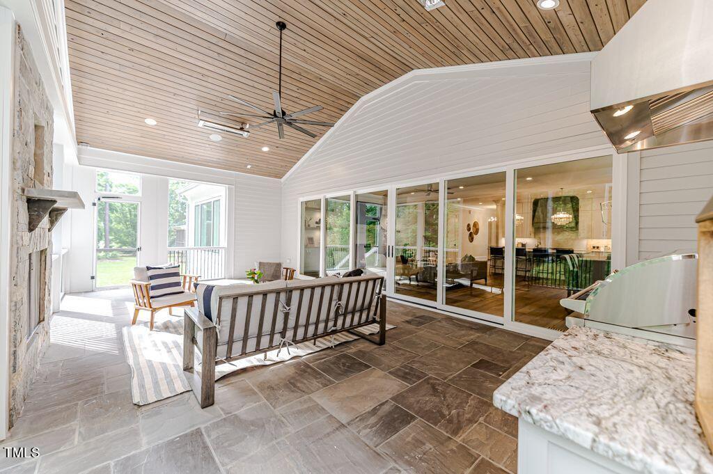 2101 Gresham Lake Road Raleigh, NC 27615 - Photo 44 of 48 a view of a patio with a table and chairs and floor to ceiling window