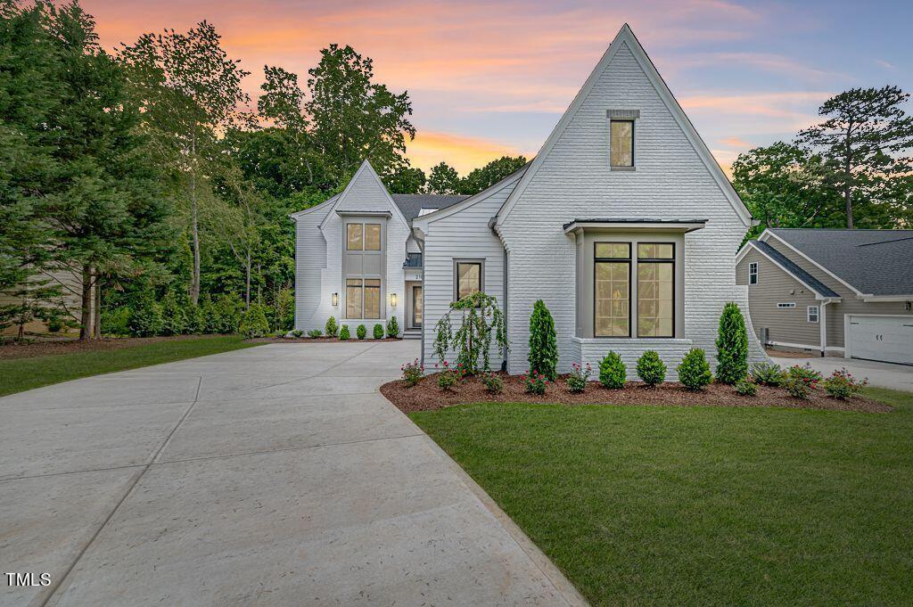 2101 Gresham Lake Road Raleigh, NC 27615 - Photo 47 of 48 a front view of a house with a yard and trees