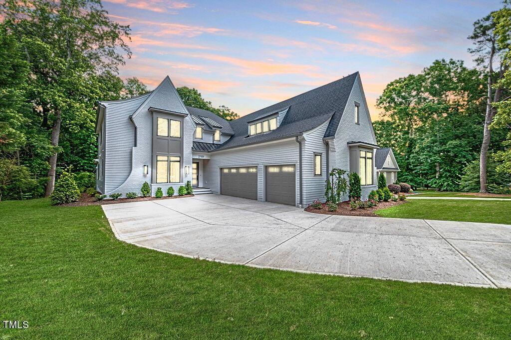 2101 Gresham Lake Road Raleigh, NC 27615 - Photo 48 of 48 a front view of a house with a yard and garage