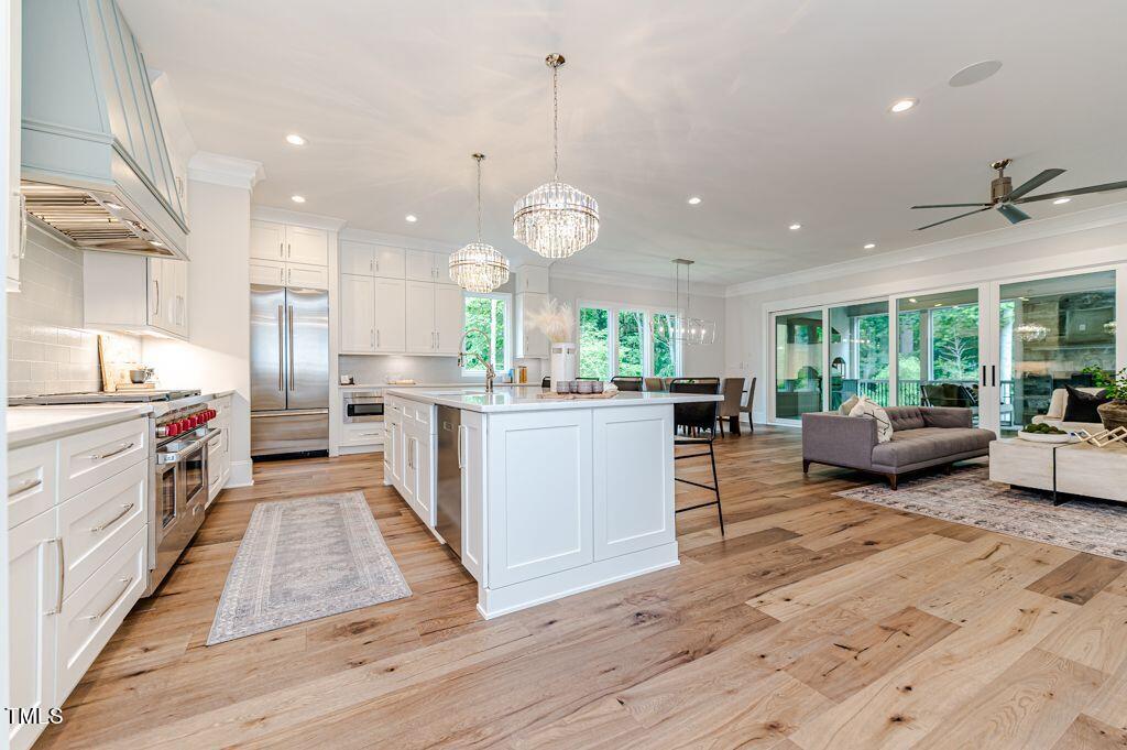 2101 Gresham Lake Road Raleigh, NC 27615 - Photo 5 of 48 an open kitchen with kitchen island and stainless steel appliances