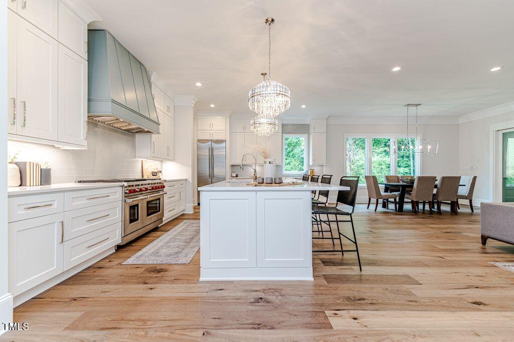 2101 Gresham Lake Road Raleigh, NC 27615 - Photo 6 of 48 a large kitchen with granite countertop a large counter space a sink appliances and cabinets