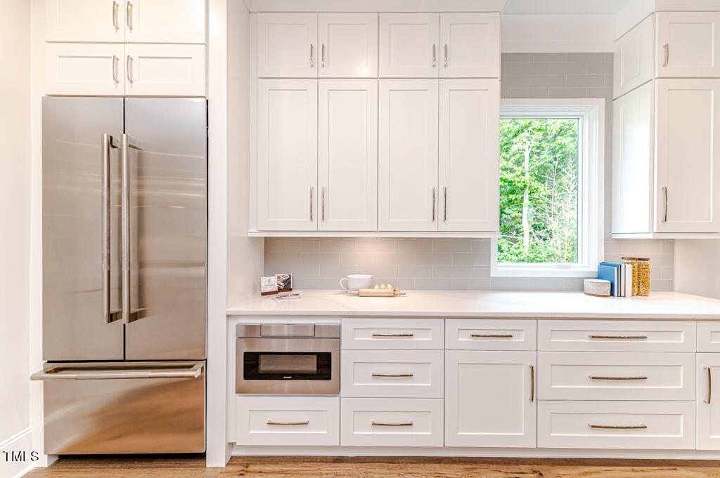 2101 Gresham Lake Road Raleigh, NC 27615 - Photo 8 of 48 a kitchen with granite countertop white cabinets and white appliances