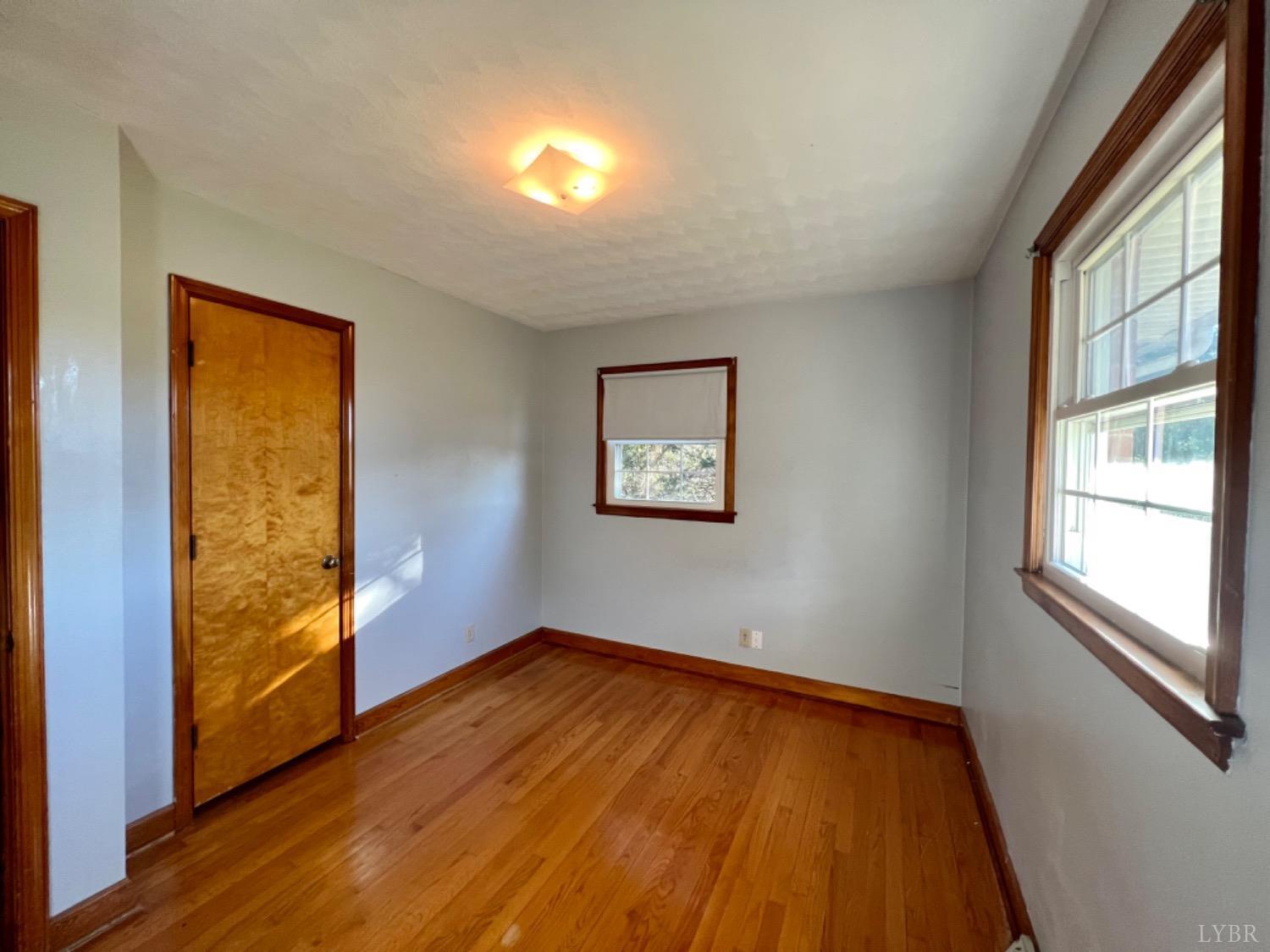 417 Jasper Wood Road Hurt, VA 24563 - Photo 11 of 36 wooden floor in an empty room with a window