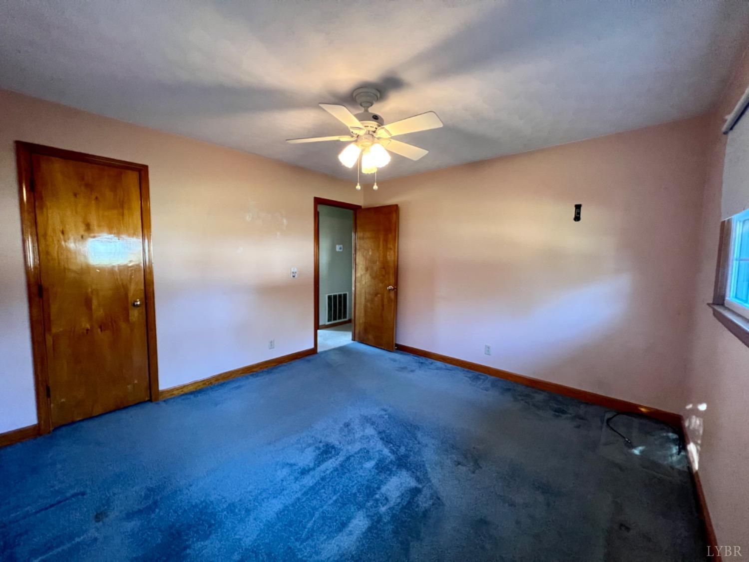 417 Jasper Wood Road Hurt, VA 24563 - Photo 12 of 36 an empty room with closet and a chandelier fan